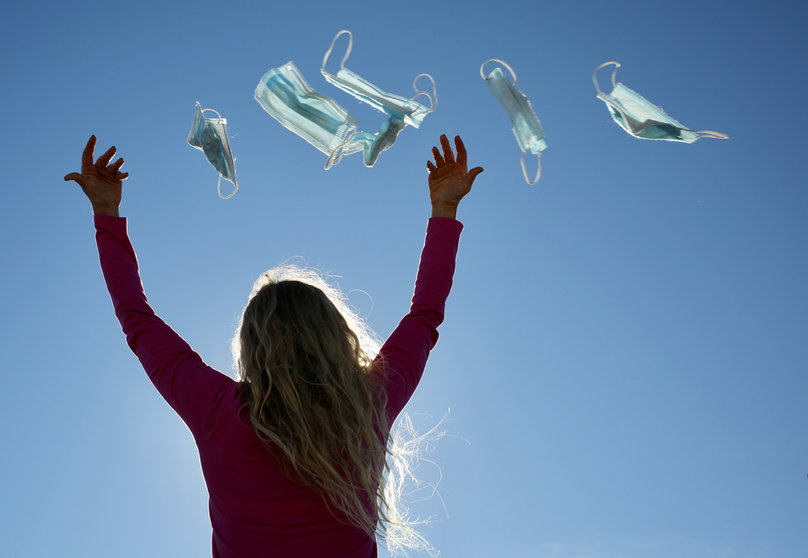 08 February 2022, Spain, Madrid: A woman throws masks into the air in Madrid. Spanish Government approves today in the Council of Ministers to end the obligatory use of face masks outdoors, a measure that will come into force on 10 February. Photo: Cézaro De Luca/EUROPA PRESS/dpa.