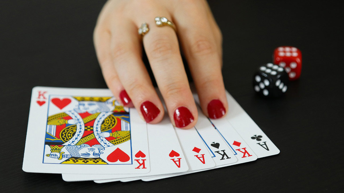 Gambling-cards-dice-woman-hand-nails