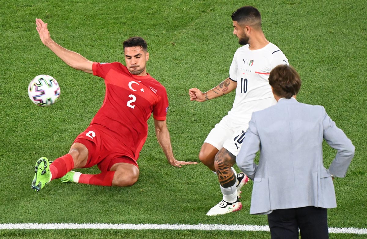 11 June 2021, Italy, Rome: Italy's Lorenzo Inisgne and Turkey's Hakan Calhanoglu battle for the ball during the UEFA EURO 2020 Group A soccer match between Italy and Turkey at the Olympic Stadium. Photo: Matthias Balk/dpa